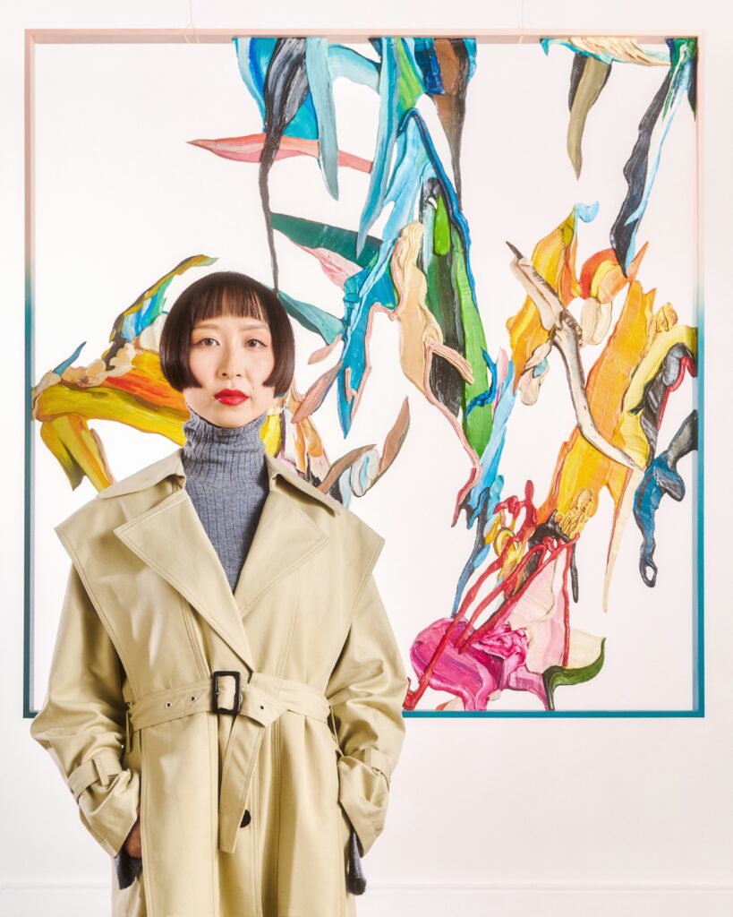 Ziling Wang in front of her painting (photo courtesy of Lou Jasmine)