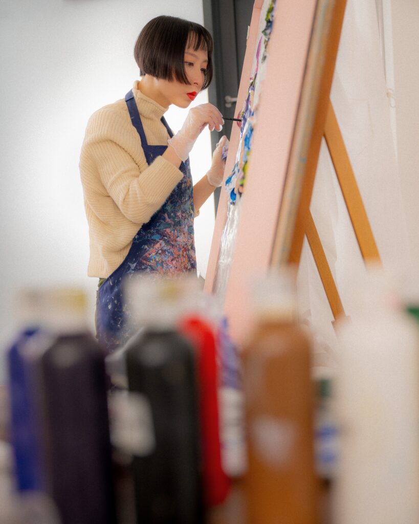 Ziling Wang painting in her studio